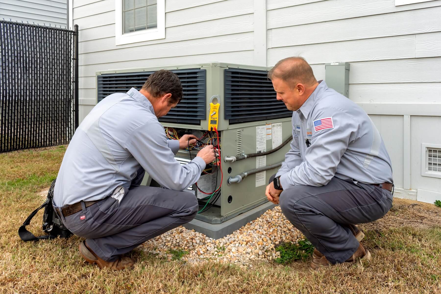 techs servicing outdoor unit